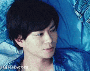 Man Lying On Bed In Blue Shirt GIF