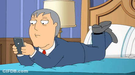 Man Lying On Bed Looking At Cell Phone GIF