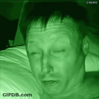 Man Lying On Bed With RDBTC Screen GIF