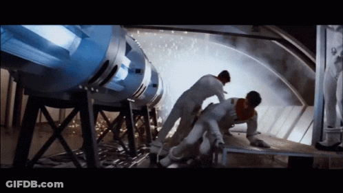 Man Lying On Ground By Large Machine GIF