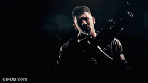 Man Lying On Ground With Machine Gun GIF