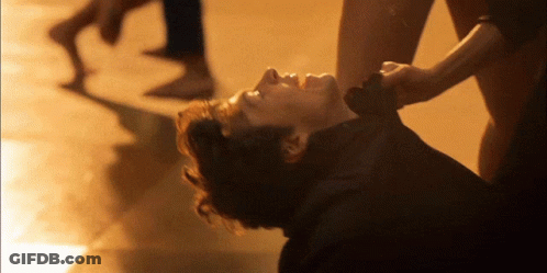 Man Lying On Ground With Woman Holding Neck GIF
