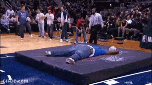 Man Lying On Mat In Front Of NBA Sign GIF