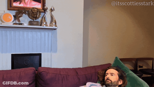 Man Lying On Purple Couch GIF