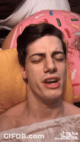 Man Lying On Sprinkled Pillow GIF