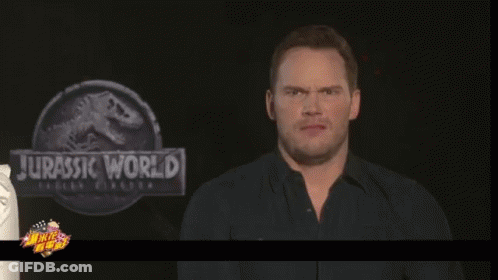 Man Making Face In Front Of Jurassic World Sign GIF