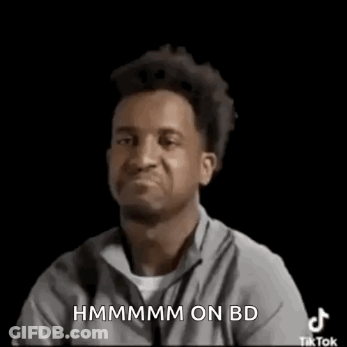 Man Making Funny Face And Pointing At Camera In Grey Shirt GIF