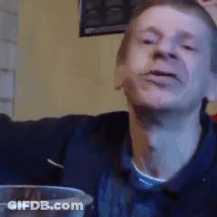 Man Making Funny Face At Table With Glass Of Water GIF