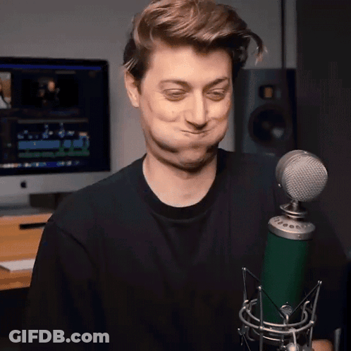Man Making Funny Face Holding Green Microphone GIF