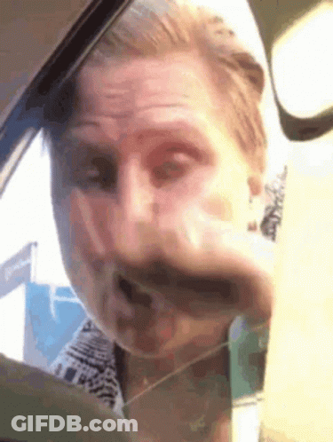 Man Making Funny Face In Car GIF
