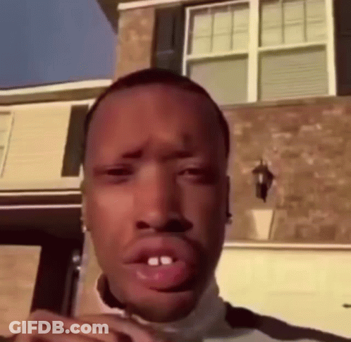 Man Making Funny Face In Front Of Brick Building GIF