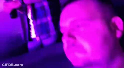 Man Making Funny Face In Front Of Purple Light GIF