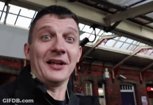 Man Making Funny Face In Front Of Red Light GIF