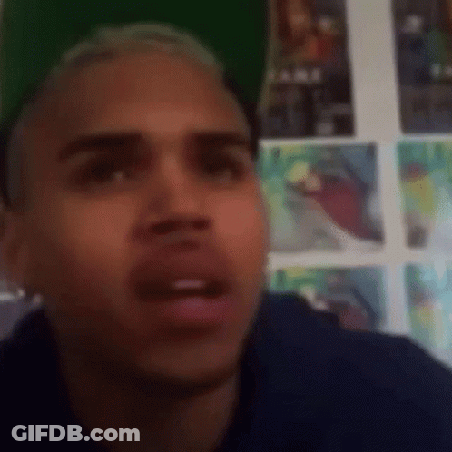 Man Making Funny Face In Front Of Wall With Posters GIF