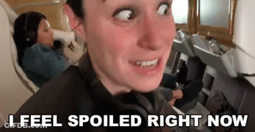 Man Making Funny Face On Plane With Woman GIF