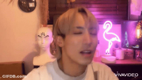 Man Making Funny Face With Flamingo Neon Sign GIF