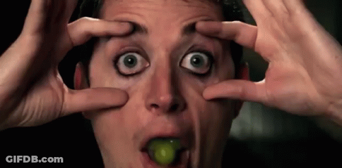 Man Making Funny Face With Grape In Mouth GIF