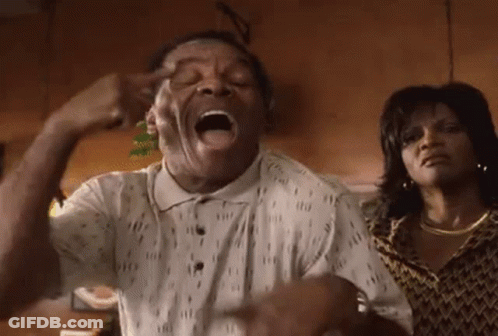 Man Making Funny Face With Woman Behind Him GIF