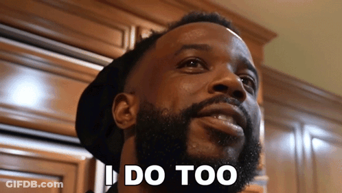 Man Making Peace Sign With Delicious Behind Him GIF