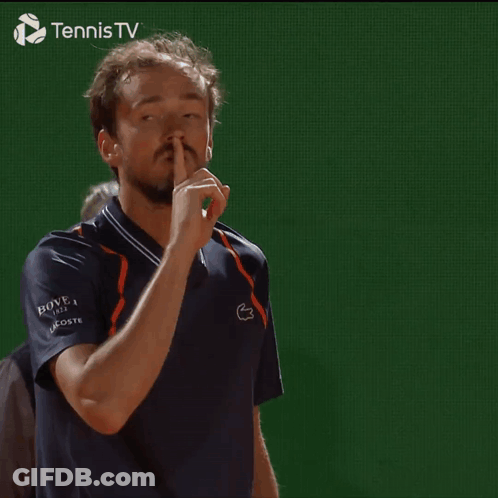 Man Making Shhh Gesture In Front Of Tennis TV Logo GIF