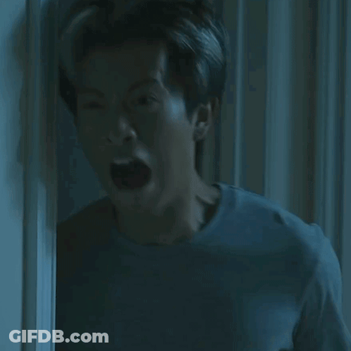 Man Mouth Open In Dark Room GIF