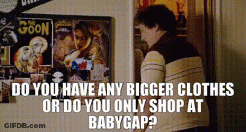 Man Next To Poster Saying Do You Have Any Bigger Clothes Or Only Shop At BabyGap GIF