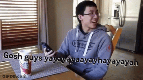 Man Nintendo Sweatshirt With Starbucks Cup At Table GIF