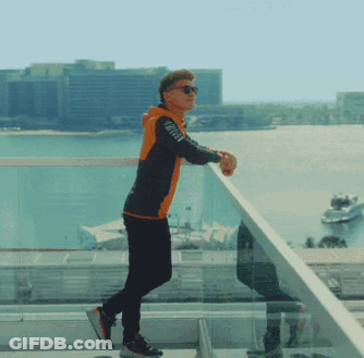 Man On Balcony Looking Over Water GIF
