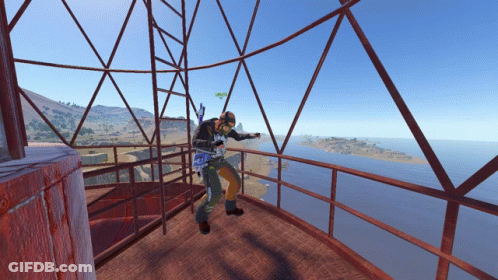 Man On Balcony Overlooking Water And Mountains GIF