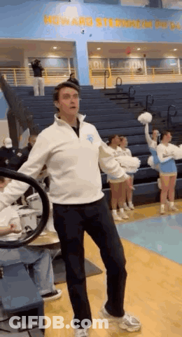 Man On Basketball Court In Front Of Cheerleader GIF