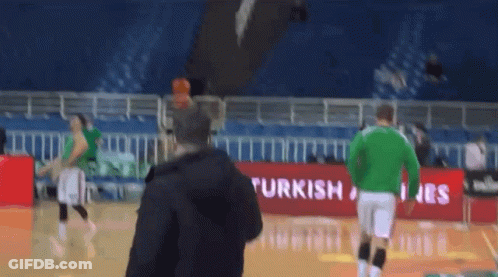 Man On Basketball Court In Front Of Turkish Airlines Banner GIF
