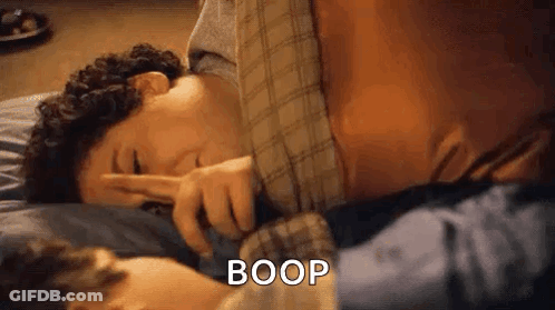 Man On Bed Making Peace Sign With Another Man GIF