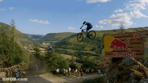 Man On Bike Jumping Over Red Bull Sign GIF