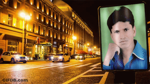 Man On Billboard In City At Night GIF