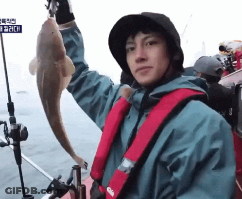 Man On Boat Holding Fish With Life Vest Saying Gill GIF