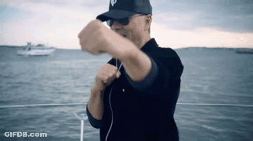 Man On Boat Wearing Hat And Sunglasses GIF