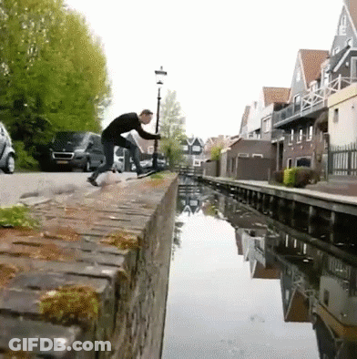 Man On Brick Wall Next To River GIF