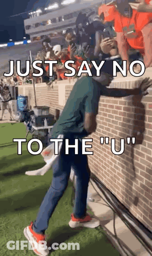Man On Brick Wall Saying Just Say No To The U GIF