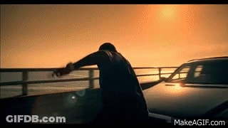Man On Bridge Overlooking Ocean With Car GIF