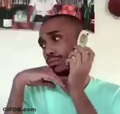 Man On Cell Phone In Front Of Man's Picture GIF