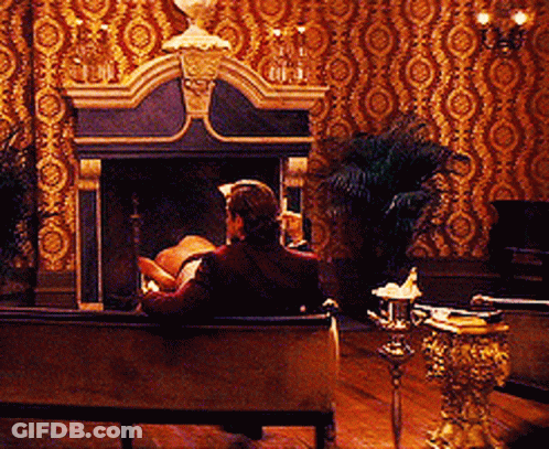 Man On Couch By Fireplace In Living Room GIF