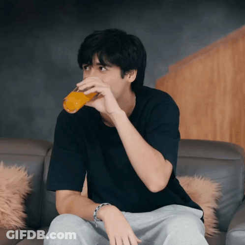 Man On Couch Drinking Orange Juice GIF