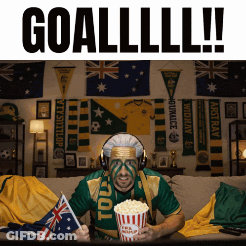 Man On Couch In Green Gold Shirt With Popcorn Saying Toul GIF