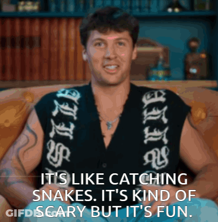 Man On Couch Saying It's Like Catching Snakes GIF