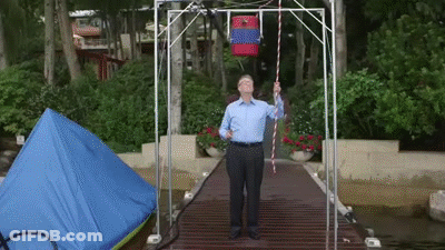 Man On Dock Holding Rope With Red Bag GIF