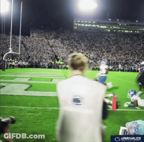 Man On Football Field Wearing Vest Saying Unrivaled GIF