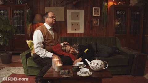 Man On Green Couch Woman On Lap GIF
