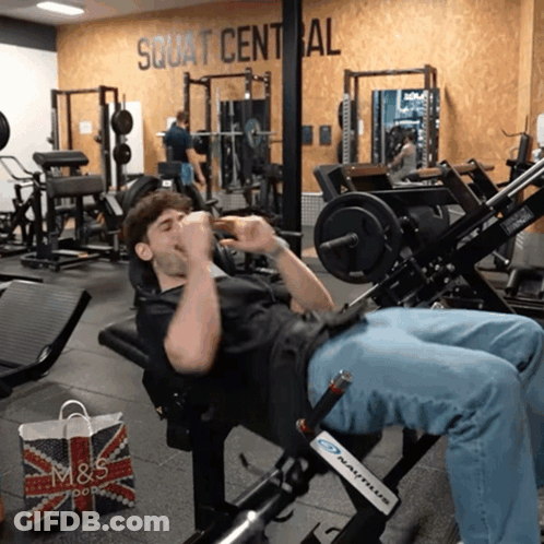 Man On Gym Machine Squat Central GIF