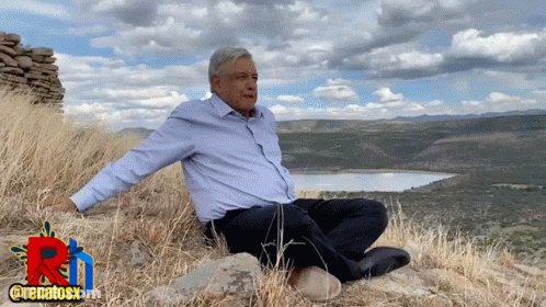 Man On Hill Arms Outstretched By Lake GIF
