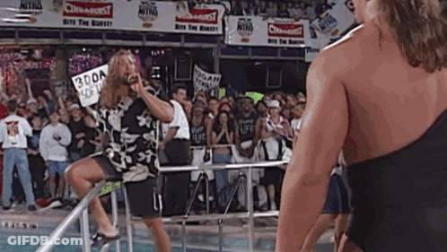 Man On Ladder In Front Of Crowd With Sign Saying 300A GIF